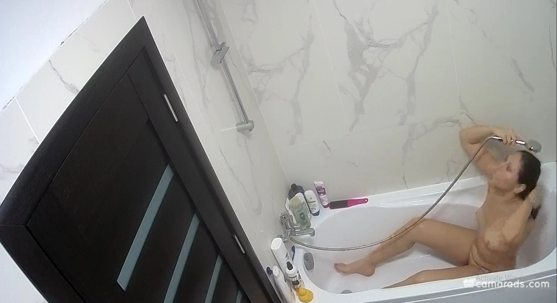 Sexy brunette is taking a bath